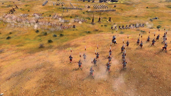 A screenshot from Age of Empires IV: Dynasties of the East showing cavalry charging towards an approaching enemy army on a grassy battlefield.