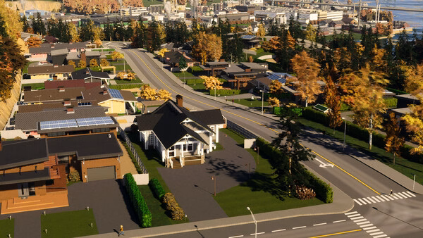 A Cities: Skylines II screenshot showing a suburban neighborhood with modern houses, autumn trees, and winding roads.