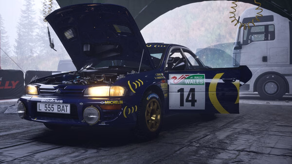 A screenshot from Assetto Corsa Rally shows a blue rally car with its hood open in a garage, marked with the number 14.